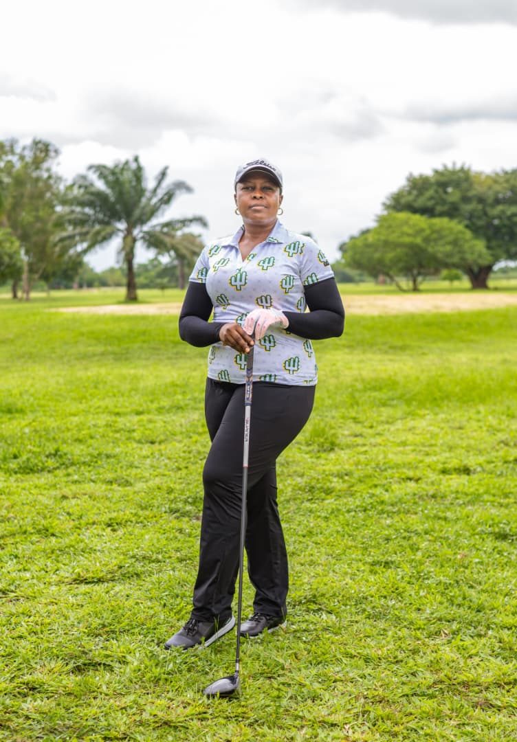 Lady member standing with her club on the course at Obinze