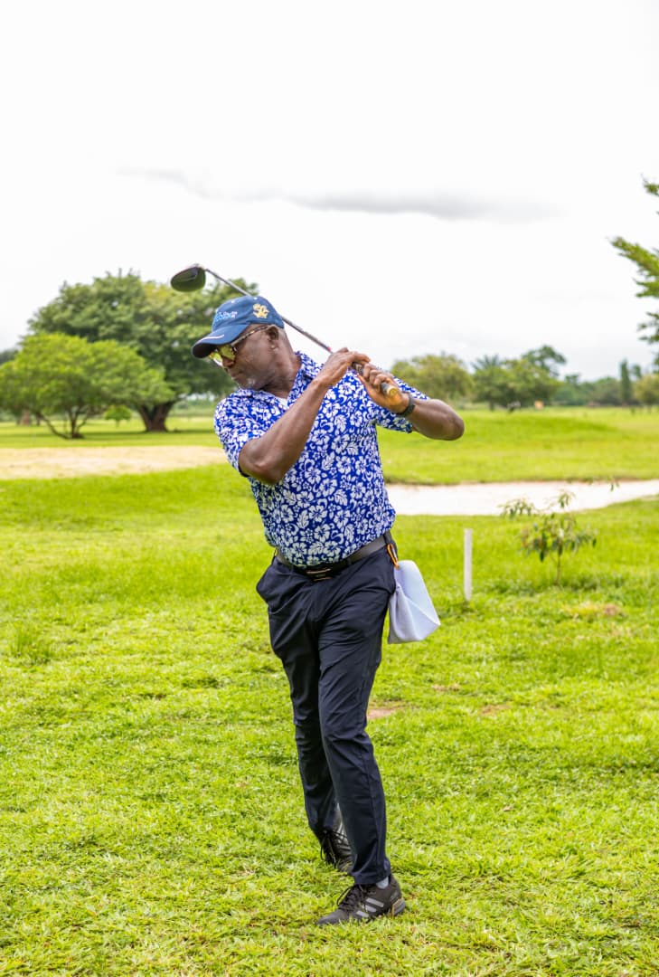 Full follow-through after a fairway shot beside the water