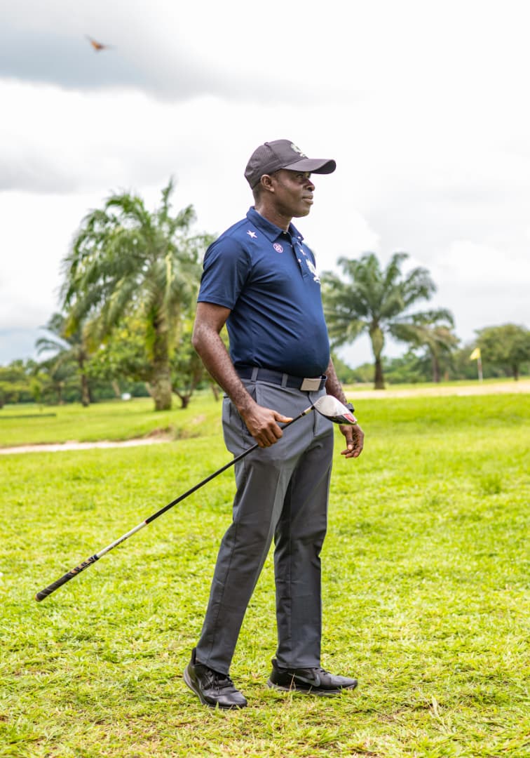 Player watching the flight of his ball towards the green