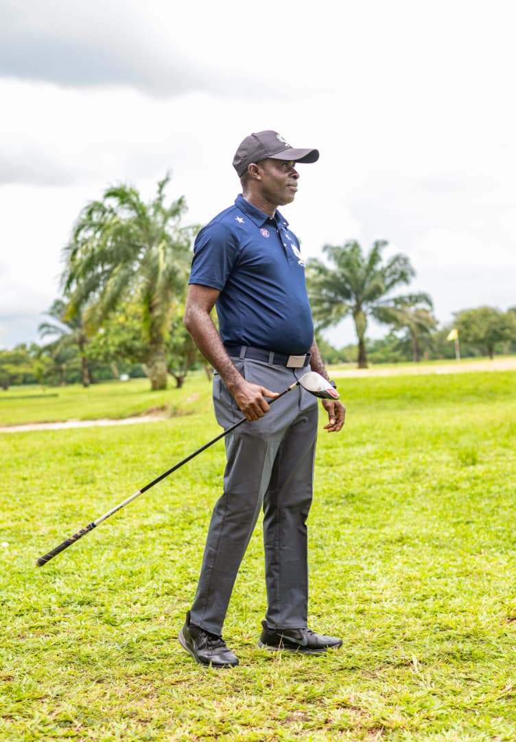 Member standing on the fairway with palms and flagstick beyond