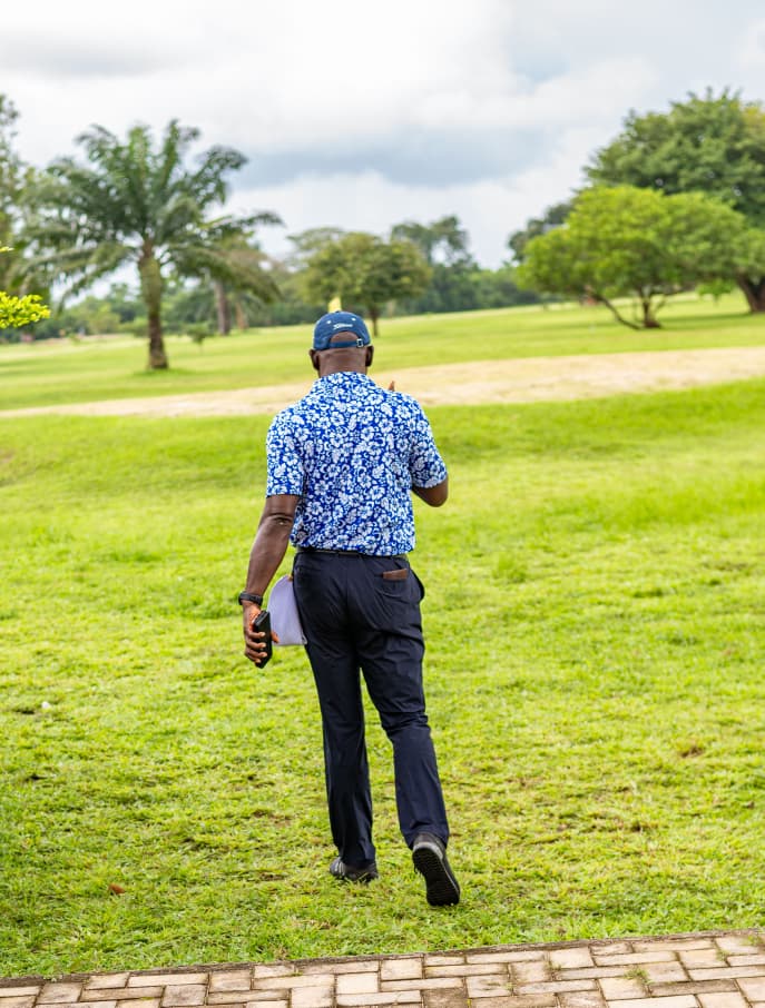 Member walking up the fairway towards the next tee