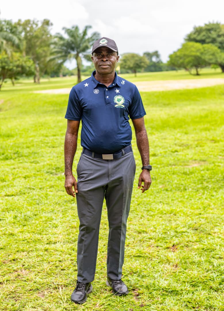 Club official in navy polo standing on the fairway