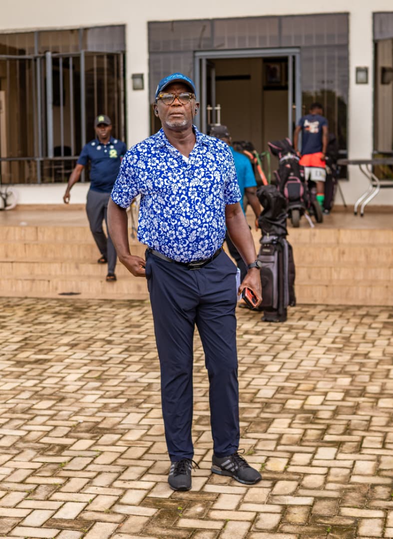 Member in blue floral polo outside the clubhouse steps