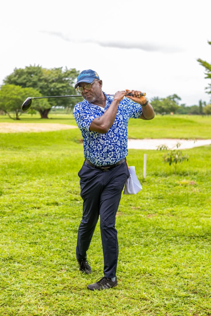 Follow-through on an approach shot beside the water hazard