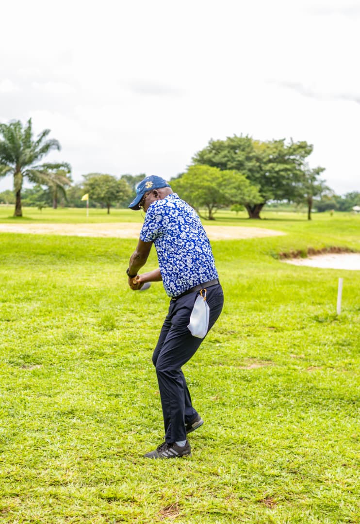 Player striking towards the yellow flagstick in the distance