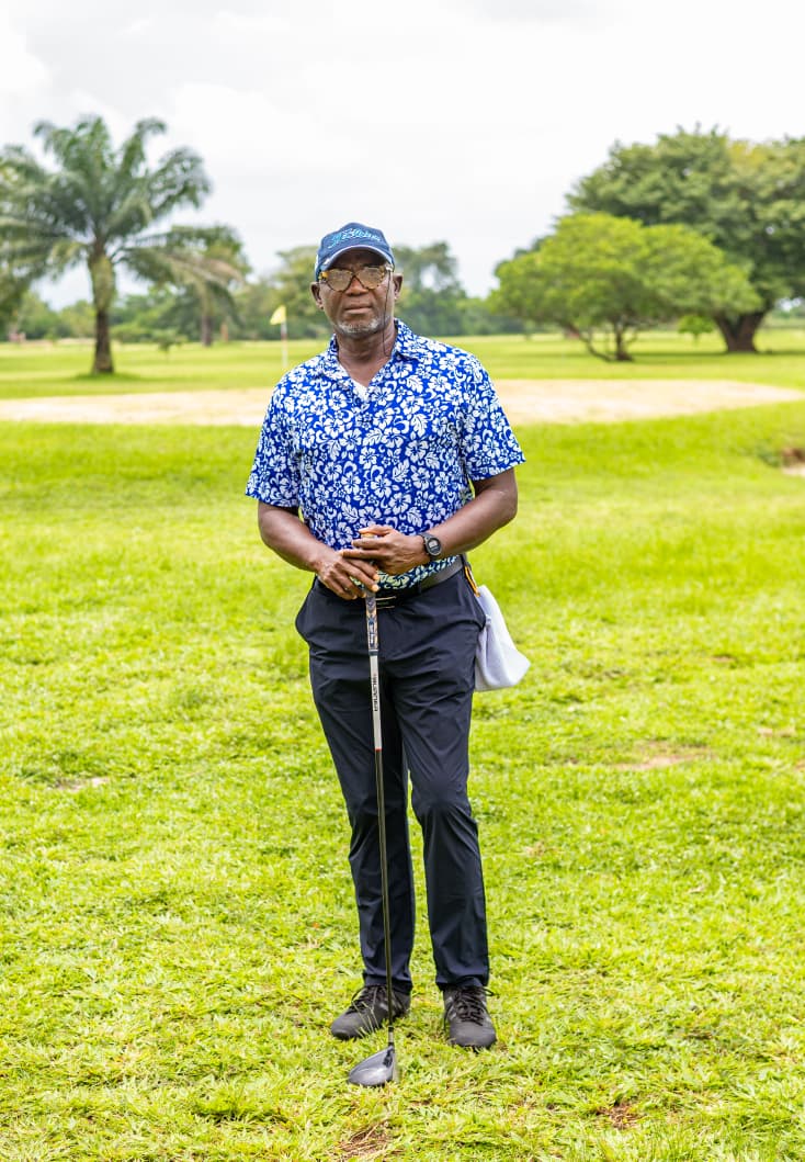 Member standing on the fairway with the green behind
